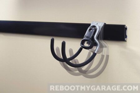 After the rail and cover are installed into the wall, start adding in your hooks.