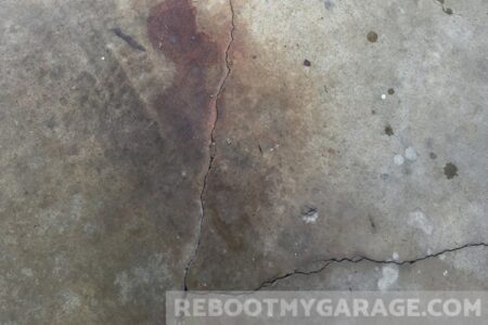 Cracks and rust stains in a concrete garage floor