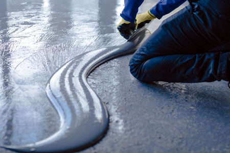 Applying wet epoxy to concrete garage floor