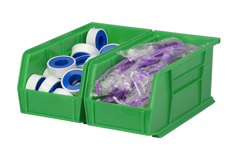 Two green open topped storage bins with plumber's tape and supplies in plastic bags