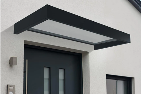 Acrylic awning with black frame over standard home door